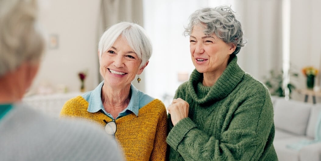 Two Elderly Women Talking Together Indoors at an Independent Living Facility