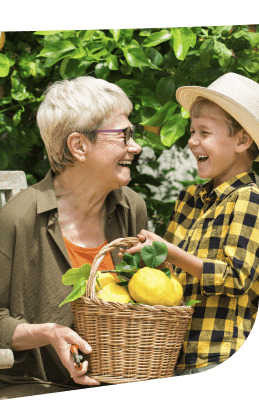 Elderly Woman Sharing a Fruit Basket With Her Grandson at an Independent Living Facility Elderly Woman Sharing a Fruit Basket With Her Grandson at an Independent Living Facility