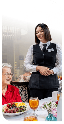 Friendly Server Attending an Elderly Woman at Dinner in an Independent Living Community