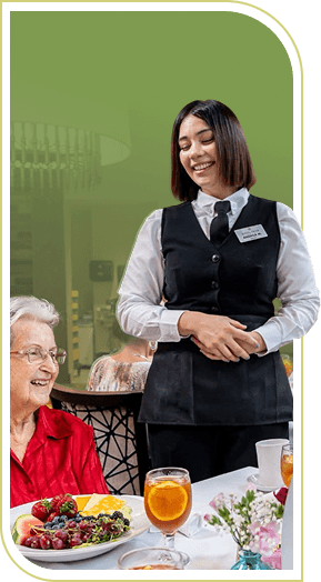 Friendly Server Attending an Elderly Woman at Dinner in an Independent Living Community