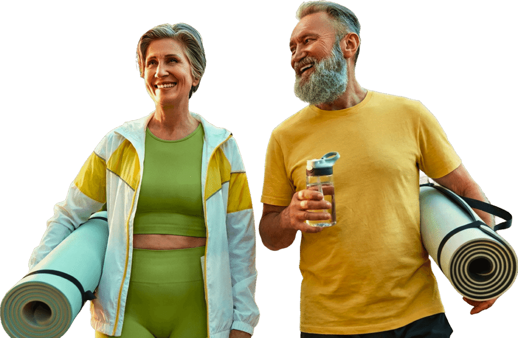 Smiling Elderly Couple Carrying Yoga Mats Outdoors at an Independent Living Community Smiling Elderly Couple Carrying Yoga Mats Outdoors at an Independent Living Community