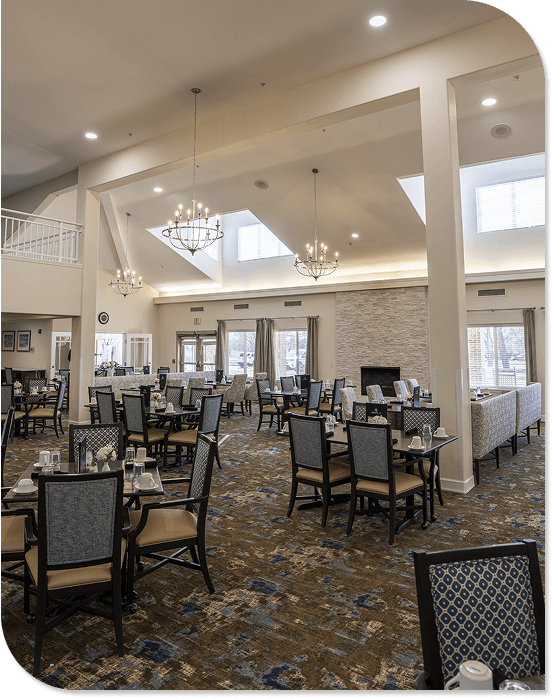 Upscale Dining Room with Cathedral Ceilings and Chandeliers at an Independent Living Community Elegant Dining Hall with High Ceilings and Chandeliers at an Independent Living Community