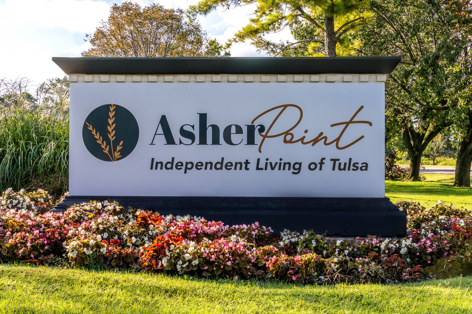 Asher Point Independent Living of Tulsa Monument Sign Surrounded by Colorful Flowers