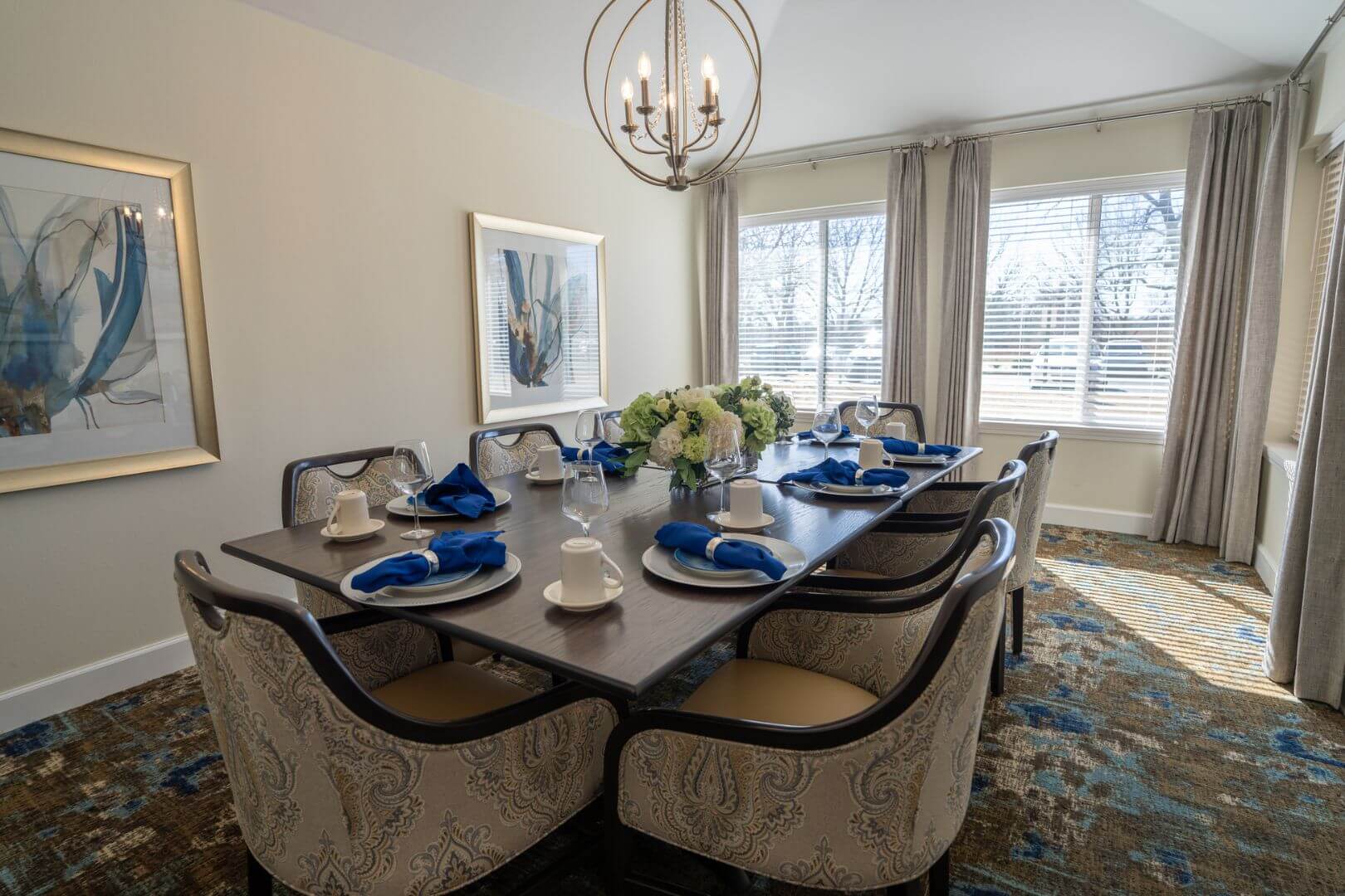 Elegant Private Dining Room with Blue Napkins and Chandelier at an Independent Living Facility