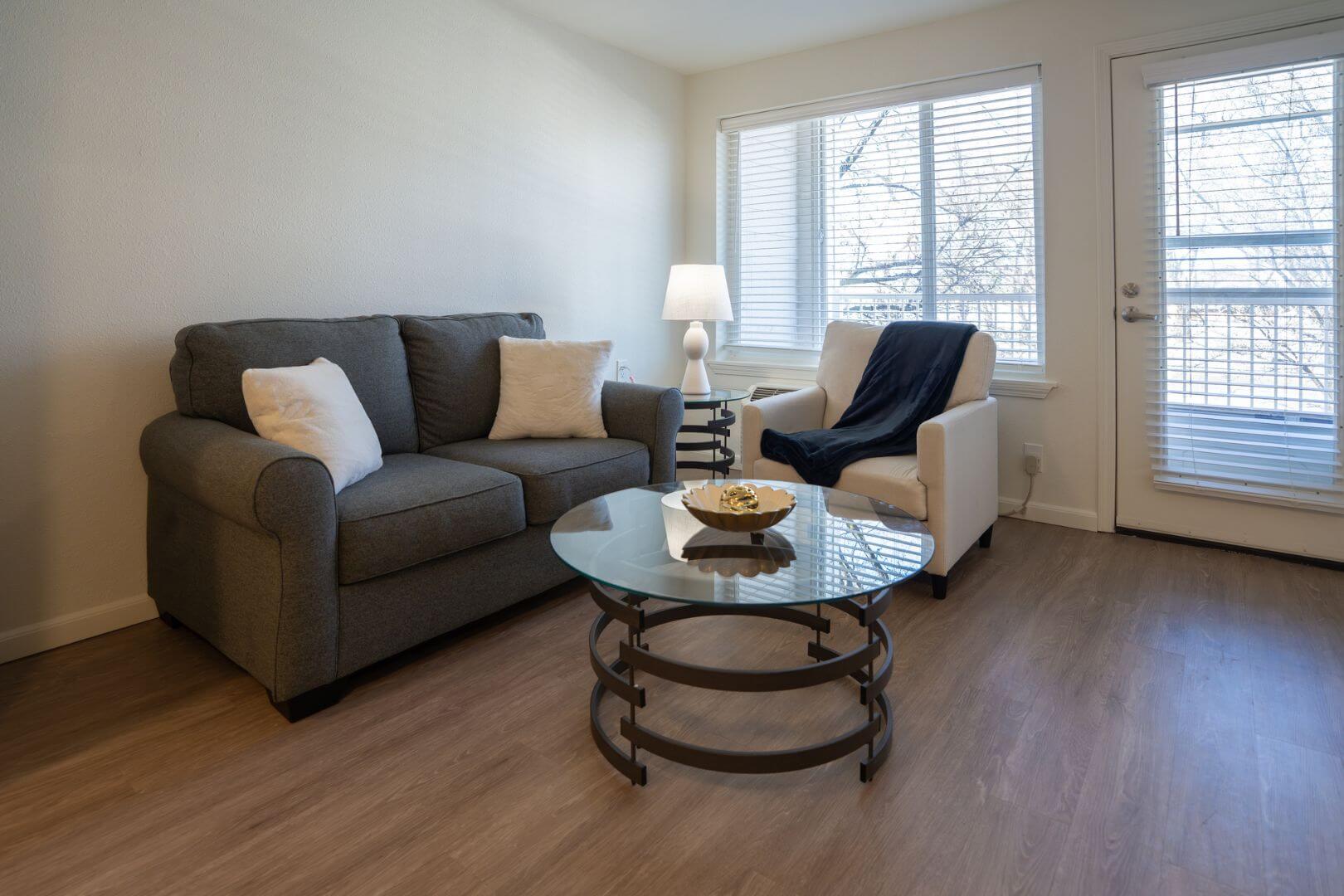 Comfortable Living Room with Sofa and Hardwood Floors at an Independent Living Community