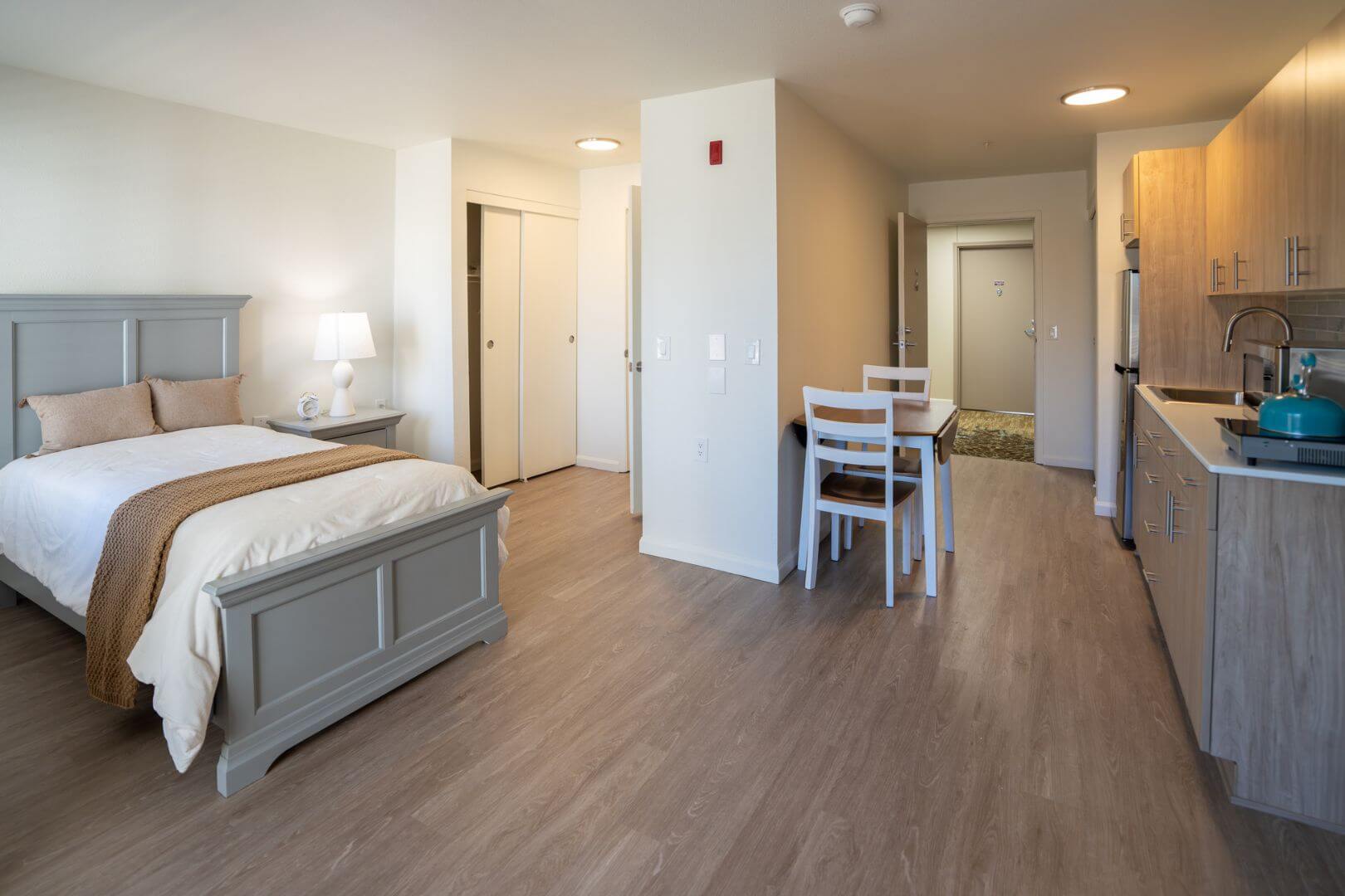 Open Studio Apartment with Bed, Dining Area, and Kitchenette at an Independent Living Facility